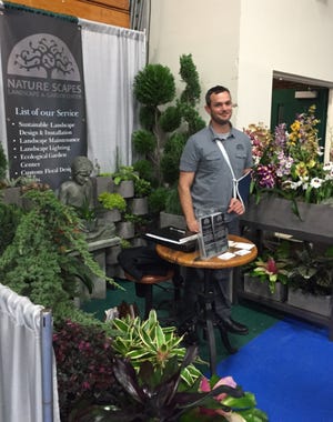 Chris Baiata carved out a little garden for the Nature Scapes booth at the Flagler Home & Lifestyle Show. NEWS-TRIBUNE/AARON LONDON