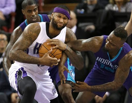 Sacramento Kings center DeMarcus Cousins, left, pulls the ball away from Charlotte Hornets forward P.J. Hairston during the first quarter of an NBA basketball game Monday, Jan. 25, 2016, in Sacramento, Calif. (AP Photo/Rich Pedroncelli)