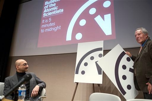 Climate scientist Richard Somerville, member, Science and Security Board, Bulletin of the Atomic Scientists, right, unveils the new "Doomsday Clock," accompanied by Sivan Kartha, member, Science and Security Board, Bulletin of the Atomic Scientists and senior scientists at the Stockholm Environmental Institute, on Jan. 22, 2015.