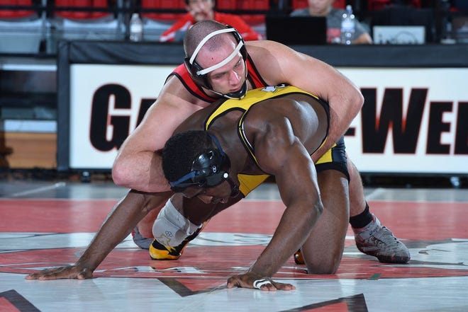GWU's Gray Jones fights for control in Tuesday's collegiate wrestling match against Appalachian State's Randall Diabe at 197 pounds at Porter Arena. The host Runnin' Bulldogs knocked off the 25th-ranked Mountaineers, 22-18.
