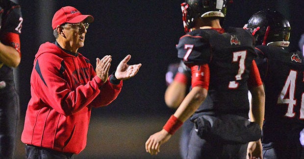 South Sumter head coach Inman Sherman claps for his team a defensive stand during a class 5A playoff game between against North Marion High School on Nov. 14, 2014. South Sumter won 16-12.