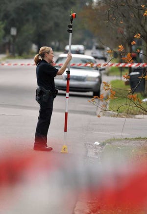 Bob.Self@jacksonville.com--1/26/16--Investigators collect evidence at the scene of a fatal shooting at the intersection of Stewart and 31st. Streets Tuesday morning, January 26, 2015. (The Florida Times-Union/Bob Self)