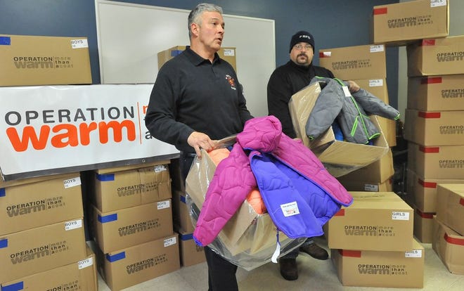 Fall River Firefighters Brian Rapoza, left, and C.J. Ponte talks about the program that will bring warm coats to Fall River children in need of them.