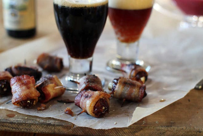 This Nov. 2, 2015 photo shows bacon wrapped Parmesan stuffed dates in Concord, N.H. The dates are easy to make, and even easier to eat. (AP Photo/Matthew Mead)