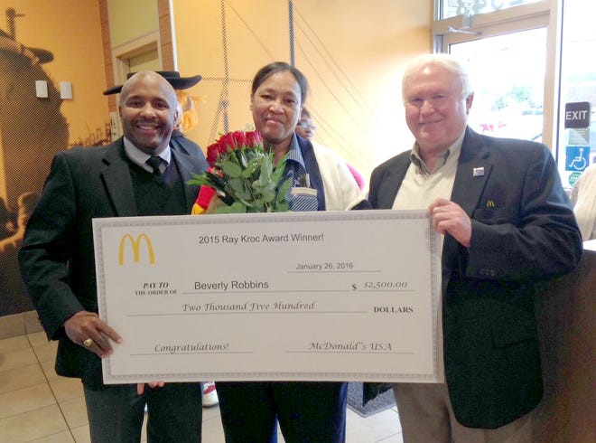 Noel Blackwood (left) and Dennis Anderson (right) present Beverly Robbins, manager of the McDonald's at at 2543 Carolina Beach Road, with a 2015 Ray Kroc Award. Robbins is one of 340 McDonald's employees worldwide to receive the honor. Courtesy of Dennis Anderson