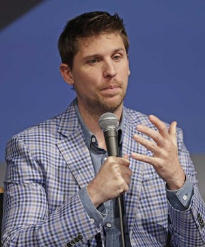 Driver Denny Hamlin answers a question during the Charlotte Motor Speedway NASCAR Media Tour in Charlotte, N.C., Tuesday, Jan. 19, 2016. (AP Photo/Chuck Burton)