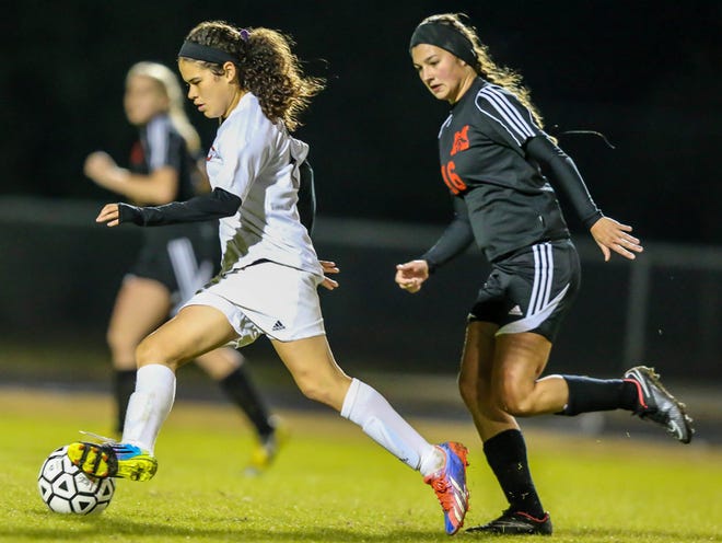 Creekside's Monica Maldonado (10), left, advances the ball defended by Middleburg's Connor Mathews (16) during the first half of girls high school soccer action at Creekside High School.