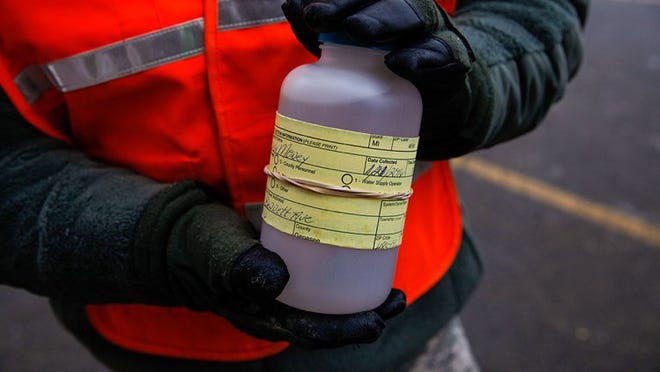The National Guard receive water samples from residents at a fire station January 21, 2016 in Flint, Michigan. The city's water supply hd been contaminated by lead after a switch from Lake Huron to the Flint river as a source in April, 2014. At the fire station, residents were provided with water testing jugs, filters and clean water brought in by the National Guard. Residents also brought in water samples from their homes which would be sent out for lead testing.