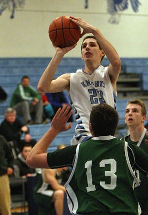 Sandwich's Andrew Galanek rises over Marshfield's Jack Masterson for a shot in Friday night's game at Sandwich. Steve Haines/Cape Cod Times