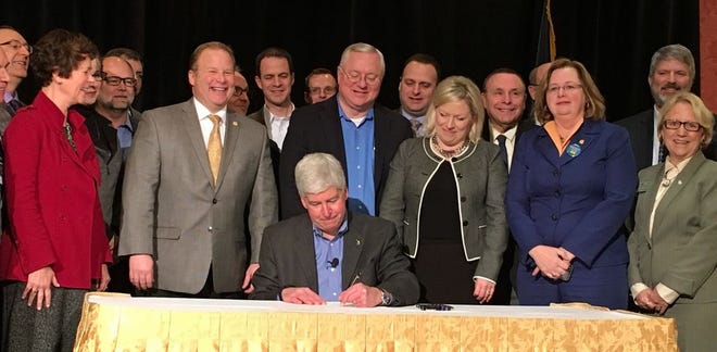 Michigan Gov. Rick Snyder signs a $28 million emergency funding bill Friday to address Flint's lead-contaminated water crisis Friday at the Michigan Press Association's annual meeting in Grand Rapids. It marks the second round of state aid since the fall, when improperly treated water was found to have leached lead from pipes into the city's supply.