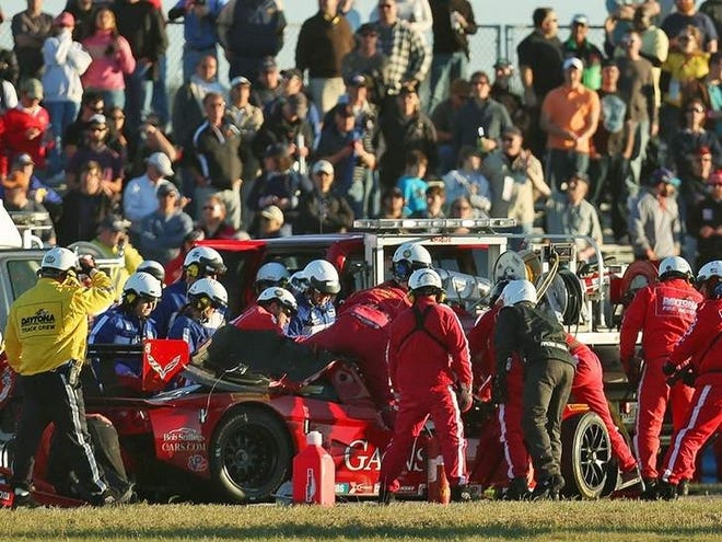 Safety workers aid Memo Gidley when he crashed with a slower car in 2014 during the Rolex 24 at Daytona. NEWS-JOURNAL FILE/DAVID TUCKER