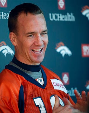 Denver Broncos quarterback Peyton Manning jokes with reporters after an NFL football practice at the team's headquarters, Thursday, Jan. 28, 2016, in Englewood, Colo. The Broncos are preparing to face the Carolina Panthers in Super Bowl 50 on Sunday, Feb. 7.