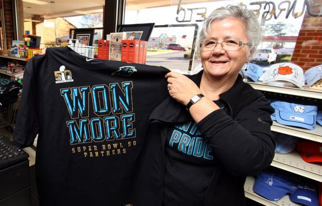 Pam Cole shows holds up a Carolina Panthers T-shirt at Medical Center Pharmacy on Cox Road on Friday morning.