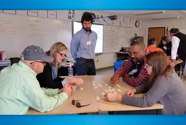 FIGURING — AHS Zoo School math teacher John Phillips oversees a math exercise Saturday. Participating are Superintendent Dr. Terry Worrell, second from left, and Asheboro board members, from left, Kyle Lamb, Phillip Cheek and Gidget Kidd. (Kathi Keys/The Courier-Tribune)