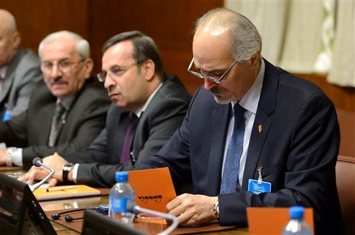 Syrian chief negotiator and the country's ambassador to the U.N. Bashar Ja'afari, right, attends the Syria peace talks in Geneva, Switzerland, Friday, Jan. 29, 2016. Indirect peace talks aimed at resolving Syria"™s five-year conflict began Friday at the U.N, headquarters in Geneva, without the participation of the main opposition group. (Martial Trezzini/Keystone via AP)