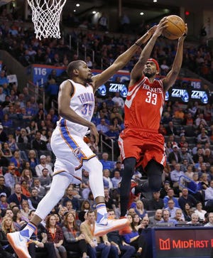 Oklahoma City Thunder forward Kevin Durant (35) defends as Houston Rockets guard Corey Brewer shoots during the second quarter of an NBA basketball game in Oklahoma City, Friday, Jan. 29, 2016. (AP Photo/Sue Ogrocki)