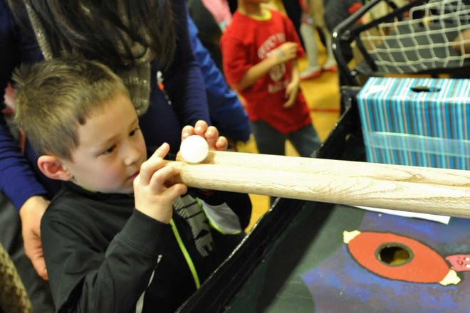 Cameron Taylor, 6, of Andover, lines up the ball during the Giant Chopsticks game at the Quincy Lunar New Year celebration on Saturday, Jan. 30, 2016. Tom Gorman/For The Patriot Ledger