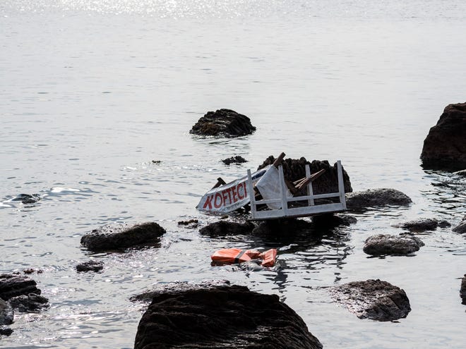 Remains of a boat that was carrying migrants seen on the shoreline near the Aegean town of Ayvacik, Canakkale, Turkey, Saturday, Jan. 30, 2016. A boat carrying migrants to Greece hit rocks off the Turkish coast on Saturday and capsized, killing at least 33 people, including five children, officials and news reports said.