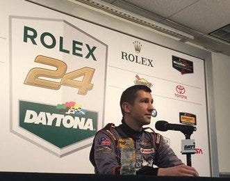 Patrick Lindsey, driver of the No. 73 Porsche, talks with the news media about his trip through the infield Sunday morning. Photo provided by IMSA