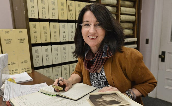 Claire Varrieur Butler, 52, of Millcreek Township, is a professional genealogist and family historian, specializing the northwest Pennsylvania region. She was photographed Jan. 15 in the Marriage Bureau at the Erie County Courthouse. Most marriage records have been digitized, but some old record books are still on display in the Marriage Bureau. CHRISTOPHER MILLETTE/