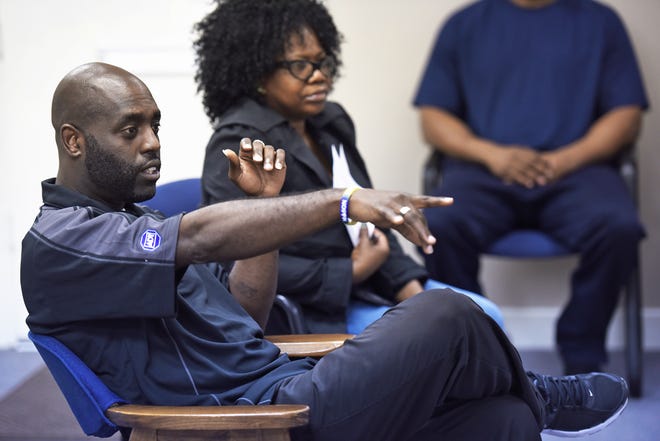 Facilitators Levi Washington, left, and Lisa Love lead a court-ordered class of men convicted of misdemeanor domestic violence at a Southside office park in Jacksonville in November. The men must go through a 26-week intervention course that focuses on how they can change their behaviors. BOB SELF/THE ASSOCIATED PRESS
