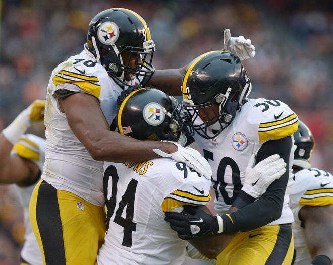 Vince Williams (98), Lawrence Timmons (94) and Ryan Shazier (50) celebrate a sack during the first half of the Steelers' Week 17 game against the Browns at FirstEnergy Stadium in Cleveland, Ohio.