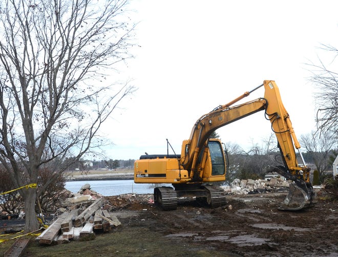 An excavator clears remaining rubble Monday from the property of the Tarbell House at 152 Portsmouth Ave. in New Castle. A fire destroyed the historic home on Jan. 23. Photo by Suzanne Laurent