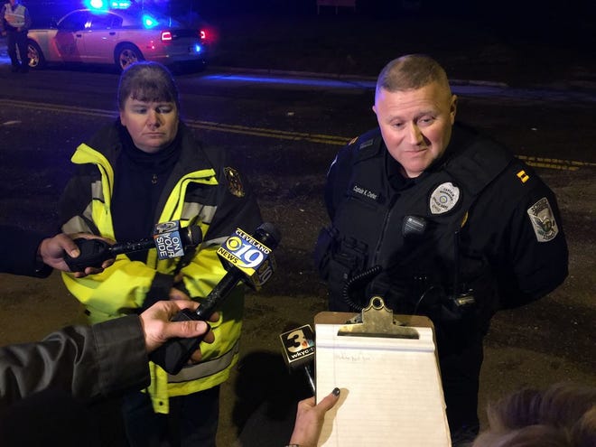 Brewster Assistant Fire Chief Jennifer Mohler and police Capt. Keith Creter update the media Monday night at the scene of a train derailment and fire at Wheeling & Lake Erie Railway.