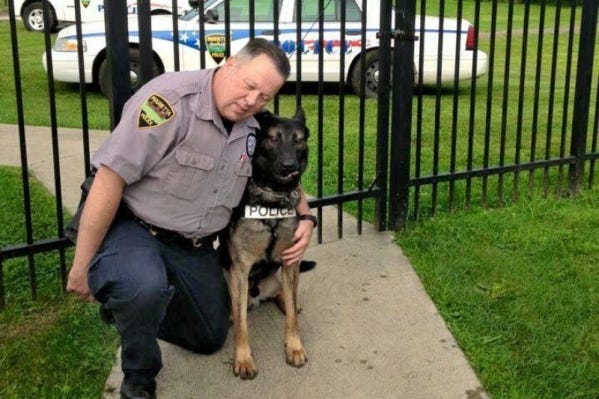 Retired Marietta K-9 Officer Matthew Hickey with his dog and partner, Ajax
