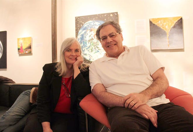 Author Michael Schacker, with his wife, Barbara, are pictured at an Art Society of Kingston exhibit, which featured works about the loss of honeybees, created by "neighbors," or patients, at the Northeast Center for Rehabilitation and Brain Injury. A stroke had left Schacker unable to promote his book, "A Spring without Bees: How Colony Collapse Disorder Has Endangered Our Food Supply" and its findings. PHOTO PROVIDED