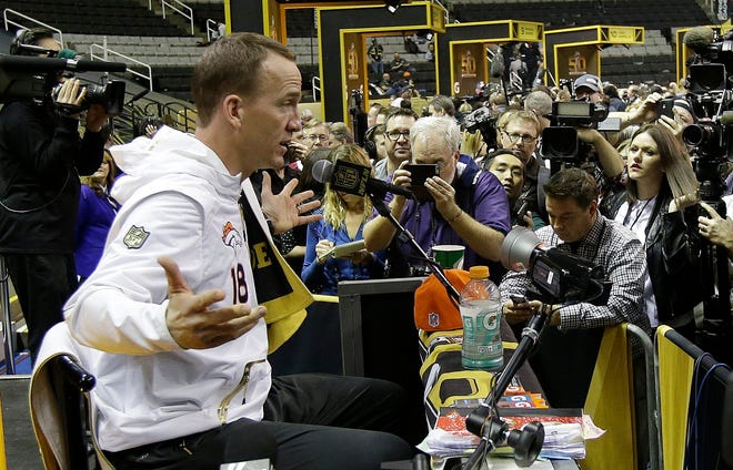 Broncos' Peyton Manning answers a question during Opening Night for Super Bowl 50. The Associated Press