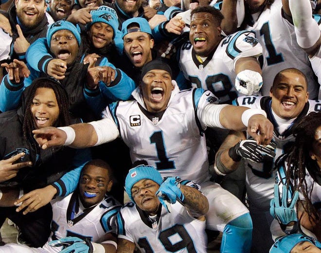 Carolina Panthers' Cam Newton celebrates with teammates following their NFC championship game win over the Arizona Cardinals to land a Super Bowl berth.