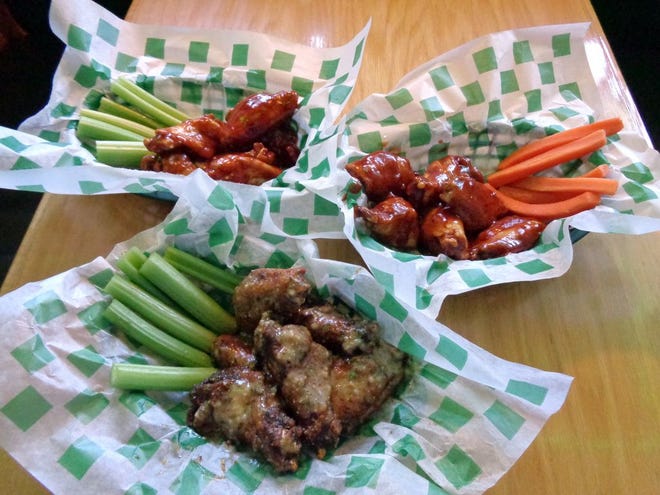 : Beef 'O' Brady's Lynn Haven location prepares Honey Hot wings (a nice mix of Beef's Hot wing sauce and Honey BBQ) served with celery, a sweeter Honey BBQ wings served with carrots and the deliciously salty “blackened old way” Garlic Parmesan Wings.