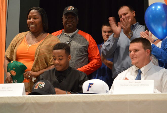 Mount Dora seniors Drew Davis, left, and Brett Heggie signed National Letters of Intent during a National Signing Day event on Wednesday at Mount Dora High School. Davis will play football at Florida A&M University and Heggie will play at the University of Florida.