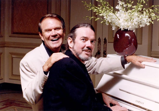 Country singer Glen Campbell (left) sits at the piano with songwriter Jimmy Webb. Webb will appear in Charlotte for the concert “Jimmy Webb: The Glen Campbell Years” on Feb. 6. (photo courtesy of Sandra Gillard-Lightkeepers)