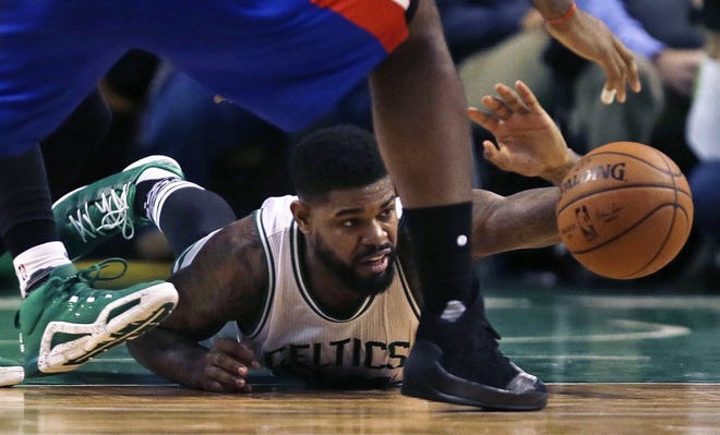 Amir Johnson of the Celtics hits the floor in pursuit of the basketball on Wednesday night.