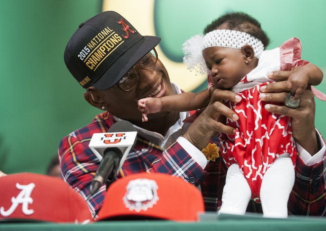 Carver High School's Mack Wilson holds his sister Lamera Wilson as he announces that he is signing with Alabama during a ceremony at the Carver campus in Montgomery, Ala. on Wednesday February 3, 2016.