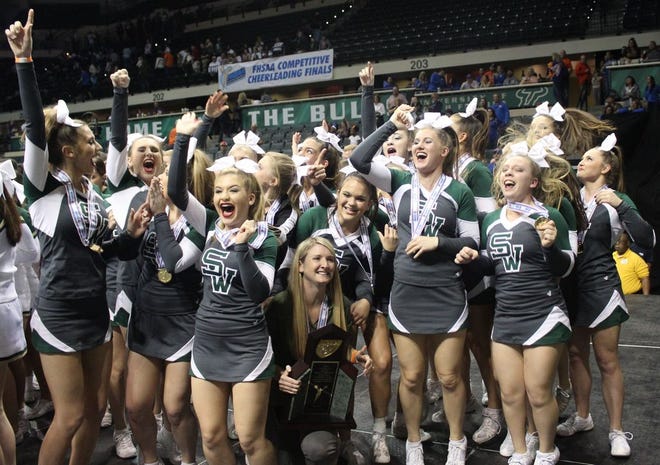 Members of the cheer team celebrate after winning the state championship trophy. Team members are Anna Jackson, Alex Page, Savannah Burden, Maci Roundtree, Jenna Kotowske, Zoe Coetzee, Maria Beabout, Alexis Workman, Georgia Barksdale, Kiera Singletary, Lydia Zemanick, Delaina White, Eliza Harris, Taylor Barakat, Rose Stransky, Ella Losee, Isabella Dumask, Savannah Bartleson, Claire Harman and Brooke Sibley. Coach is Ashlee Scarpulla.