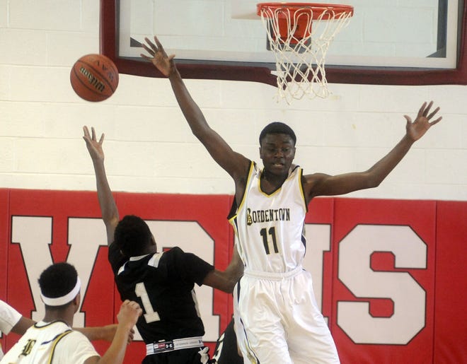 Manny Ansong of Bordentown blocks the shot by Nathan Carpenter of Bishop Eustace in the second quarter at Saturday's Jeff Coney Classic at Rancocas Valley High School.