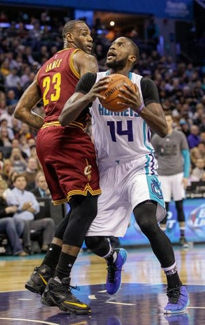 Charlotte Hornets forward Michael Kidd-Gilchrist, right, drives into Cleveland Cavaliers forward LeBron James during the first half of their game Wednesday in Charlotte. The Hornets used a big third quarter to take a 106-97 victory.
