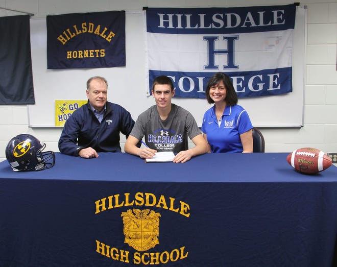 Hillsdale Hornet football standout Josef Philipp (center) signed a letter of intent Wednesday to play football at Hillsdale College. Also pictured are Josef's parents Al and Diane Philipp. MIKE LINVILLE PHOTO