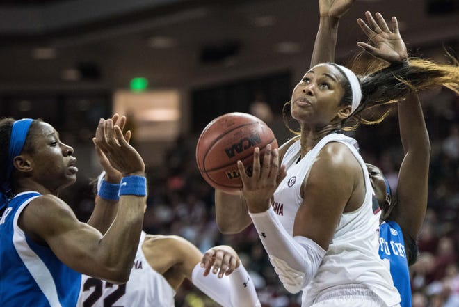 South Carolina center Alaina Coates, right, drives to the hoop against Kentucky forward Evelyn Akhator on Thursday evening in Columbia. Sean Rayford/The Associated Press
