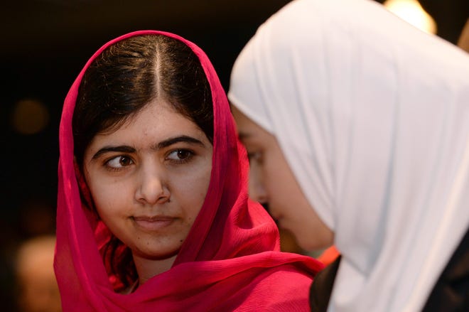 Nobel Peace Prize winner Malala Yousafzai, left, from Pakistan and 17-year-old Syrian refugee Mazoun Almellehan, during the first focus event on education at the 'Supporting Syria and the Region' conference at the Queen Elizabeth II Conference Centre in London, Thursday, Feb. 4, 2016. Leaders and diplomats from 70 countries are meeting in London Thursday to pledge billions to help millions of Syrians displaced by war, and try to slow the chaotic exodus of refugees to Europe. (Stefan Rousseau Pool via AP)