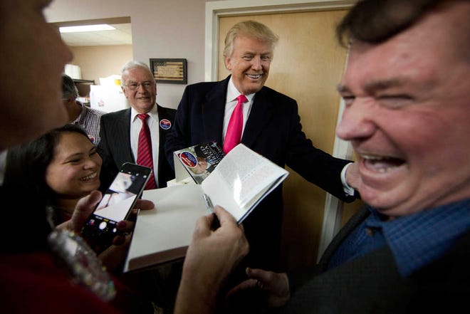 Republican presidential candidate Donald Trump visits a campaign office Tuesday, Feb. 2, 2016, in Manchester, N.H. (AP Photo/Matt Rourke)