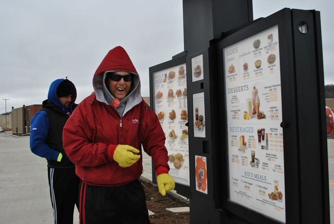 Jeff Albright of East Peoria walks through the drive-thru at Chick-Fil-A while camping out Feb. 3. Those first 100 camping out were offered snacks and meals from Chick-Fil-A.