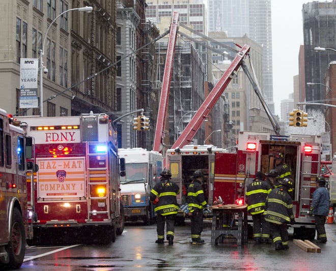 Emergency personnel work at the scene of a fatal crane collapse in the Tribeca neighborhood of Manhattan in New York on Friday, Feb. 5, 2016. (AP Photo/Mary Altaffer)