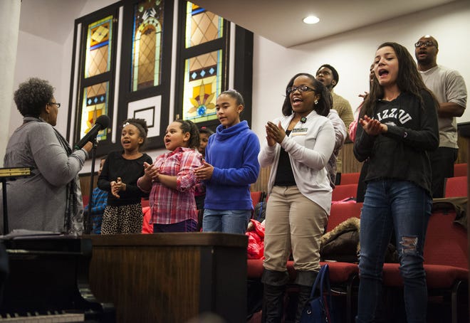 Marcia Collins directs the youth choir in a rehearsal Thursday at Second Missionary Baptist Church, which is preparing for a Sunday event to celebrate its 150th year.