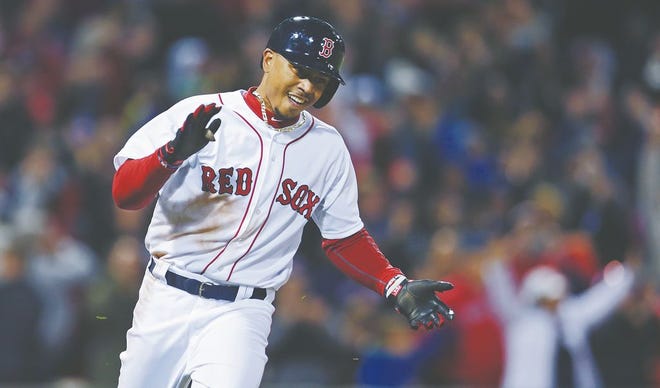 Boston Red Sox's Mookie Betts celebrates his game-winning RBI single against Toronto Blue Jays relief pitcher Miguel Castro, which drove in Xander Bogaerts and broke a 5-5 tie, during the bottom of the ninth inning of a baseball game at Fenway Park in Boston, Monday, April 27, 2015. The Red Sox won 6-5. (AP Photo/Charles Krupa)