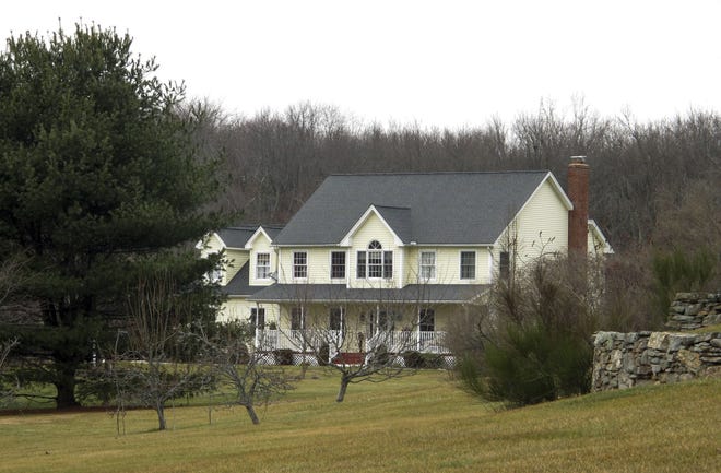 In this Feb. 4, 2016 photo, the Dabate home sits partially hidden by trees in Ellington, Conn. While responding to a burglary alarm on Dec. 23, authorities found Connie Dabate, mother of two children, shot to death and her husband Richard Dabate injured inside the house. No arrests have been made, leaving local residents concerned and speculating. (AP Photo/Dave Collins)