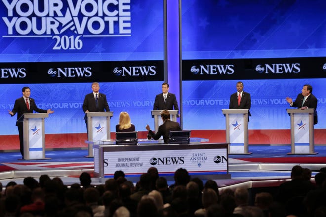 Republican presidential candidate, Sen. Marco Rubio (left), R-Fla., spars with Republican presidential candidate, New Jersey Gov. Chris Christie (right), as Republican presidential candidate businessman Donald Trump, Republican presidential candidate, Sen. Ted Cruz, R-Texas, and Republican presidential candidate, retired neurosurgeon Ben Carson listen during a Republican presidential primary debate hosted by ABC News at the St. Anselm College on Saturday in Manchester, New Hampshire.